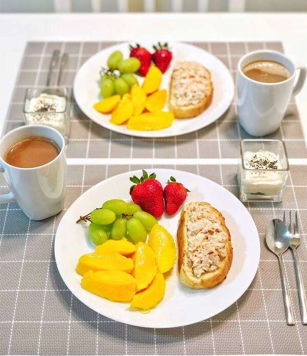 Simple breakfast table with fresh food, fruit, and warm natural light